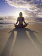 Woman Meditating on Beach