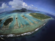 Waves Break on a Reefs Edge Near a Cluster of Small Islands